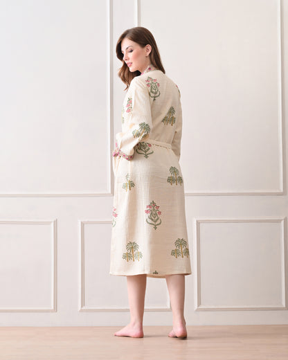  Island Flora White Cotton Waffle Bathrobe with hand block printed floral design, pink border, long sleeves, waist tie belt, worn by a woman | Singhvis 