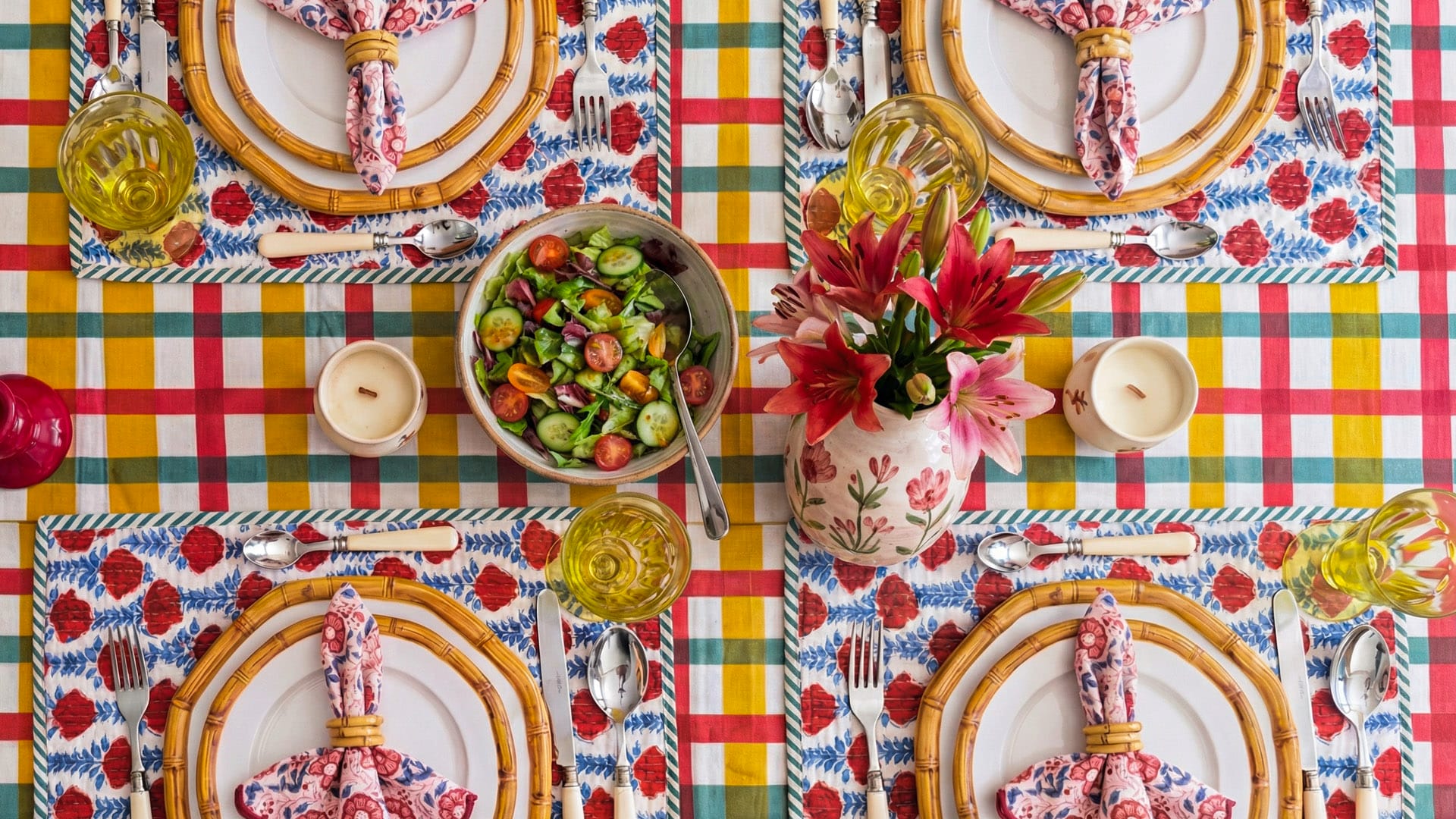 Colorful table setting with plates, cutlery, and floral napkins on a checkered tablecloth | Bring Your Table Alive This Spring | Singhvis